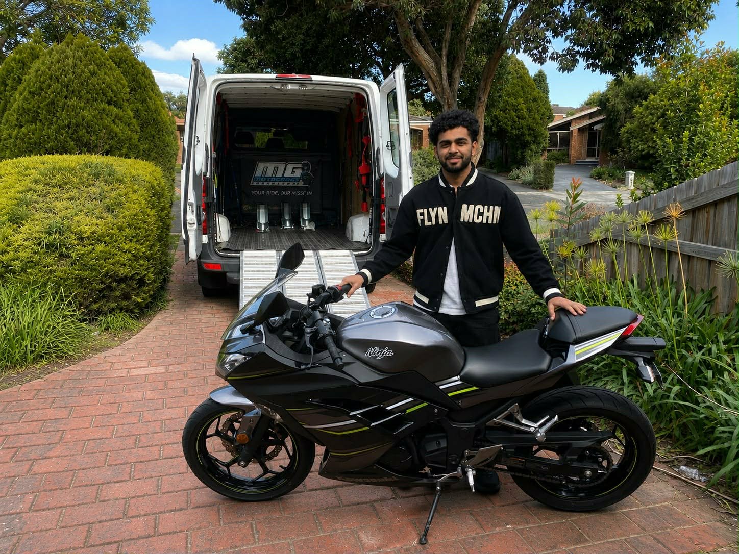 Customer with sports motorcycle beside the Motorcycle Transport Melbourne van